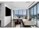 Modern living room features hardwood floors, white couches, and expansive windows with city views at 2700 Las Vegas Blvd # 4306, Las Vegas, NV 89109