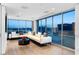 Modern living room features hardwood floors, white couches, and expansive windows with city views at 2700 Las Vegas Blvd # 4306, Las Vegas, NV 89109