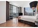 Spacious main bedroom showcasing hardwood floors, expansive windows, and modern décor at 2700 Las Vegas Blvd # 4306, Las Vegas, NV 89109