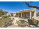 Inviting covered back patio area perfect for outdoor entertaining with desert landscaping at 2715 Riceville Dr, Henderson, NV 89052