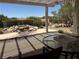 Cozy covered patio with pergola offering views of the landscaped backyard and water feature at 2715 Riceville Dr, Henderson, NV 89052