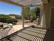 Relaxing covered patio with desert landscaping in the backyard, ideal for outdoor living at 2715 Riceville Dr, Henderson, NV 89052