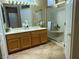 Bathroom featuring dual sinks, a glass shower, and tile floors at 2715 Riceville Dr, Henderson, NV 89052