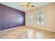 Bedroom features a ceiling fan and two bright windows, complemented by neutral and accent walls at 2715 Riceville Dr, Henderson, NV 89052