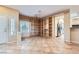 The den features an open bookshelf, tile floors, and natural light at 2715 Riceville Dr, Henderson, NV 89052