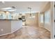 Open dining area with tile floors, a modern light fixture, and access to the kitchen at 2715 Riceville Dr, Henderson, NV 89052