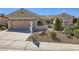 Charming single-story home featuring desert landscaping, secure gated entry, and a spacious two-car garage at 2715 Riceville Dr, Henderson, NV 89052