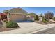 Single-story home featuring desert landscaping, secure gated entry, and a spacious two-car garage at 2715 Riceville Dr, Henderson, NV 89052