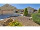 Charming single-story home featuring desert landscaping, secure gated entry, and a spacious two-car garage at 2715 Riceville Dr, Henderson, NV 89052