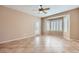 Bright living room with tiled flooring, large windows, and a ceiling fan at 2715 Riceville Dr, Henderson, NV 89052
