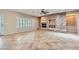 Spacious living room featuring a modern stone fireplace and tile floor at 2715 Riceville Dr, Henderson, NV 89052