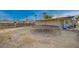 Expansive backyard with desert landscaping and a trampoline, perfect for outdoor fun at 2716 Saint George St, North Las Vegas, NV 89030