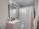 Bathroom featuring shower with curtain, vanity, and mirror at 2716 Saint George St, North Las Vegas, NV 89030