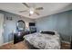 Bedroom with ceiling fan, patterned bedspread, dresser, and television at 2716 Saint George St, North Las Vegas, NV 89030