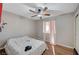 Bedroom with wood floor, ceiling fan, and window with curtains at 2716 Saint George St, North Las Vegas, NV 89030