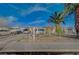 Modest single-story home featuring a chain-link fence, driveway, and various vehicles parked out front at 2716 Saint George St, North Las Vegas, NV 89030