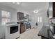 Efficient kitchen space with appliances, a door, and bright lighting at 2716 Saint George St, North Las Vegas, NV 89030