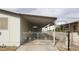 View of gated carport with white metal gate and parking for one car at 3231 Comitan Ln, Las Vegas, NV 89122