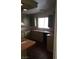 Galley-style kitchen featuring wood-look flooring, olive cabinets, and a window over the sink at 3231 Comitan Ln, Las Vegas, NV 89122