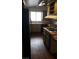 Kitchen featuring wood-look flooring, olive cabinets, and a center island with an electric cooktop at 3231 Comitan Ln, Las Vegas, NV 89122