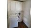 A laundry room with wood-look flooring and a white washing machine at 3231 Comitan Ln, Las Vegas, NV 89122