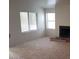 View of an empty carpeted living room with a non-functioning fireplace at 3231 Comitan Ln, Las Vegas, NV 89122