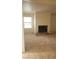 Spacious living room featuring plush carpet, a window, and a cozy fireplace at 3231 Comitan Ln, Las Vegas, NV 89122