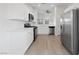 Modern kitchen showcases stainless steel appliances, white cabinetry, and new floors at 3519 Greenwick Dr, North Las Vegas, NV 89032