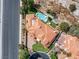 An aerial view of the house showcases the tile roof, backyard pool, desert landscaping and overall lot layout at 42 Sawgrass Ct, Las Vegas, NV 89113