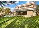 Luxury backyard featuring a large green lawn, a patio, and large windows at 42 Sawgrass Ct, Las Vegas, NV 89113