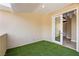 Outdoor balcony space covered in artificial grass with indoor access at 42 Sawgrass Ct, Las Vegas, NV 89113