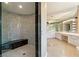 Luxurious bathroom with curved tile shower and dual vanities at 42 Sawgrass Ct, Las Vegas, NV 89113
