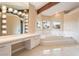 Luxurious bathroom featuring a soaking tub and vanity with great natural light at 42 Sawgrass Ct, Las Vegas, NV 89113