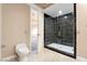 Bathroom with black tiled shower and glass enclosure next to toilet at 42 Sawgrass Ct, Las Vegas, NV 89113