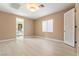 Bright bedroom with wood floors, neutral walls, and natural light from a window at 42 Sawgrass Ct, Las Vegas, NV 89113