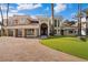 Gorgeous home featuring a well-manicured lawn, a brick driveway, and a glass garage door at 42 Sawgrass Ct, Las Vegas, NV 89113