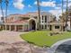 Stunning home with a beautiful lawn, large windows, and a spacious three-car garage at 42 Sawgrass Ct, Las Vegas, NV 89113