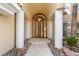 Elegant front door with white pillars and stone landscape at 42 Sawgrass Ct, Las Vegas, NV 89113