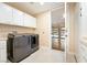Well-equipped laundry room with a modern washer and dryer, and ample storage space at 42 Sawgrass Ct, Las Vegas, NV 89113