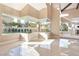 Large living room area with views to the grounds, lots of natural light, and sleek tile flooring at 42 Sawgrass Ct, Las Vegas, NV 89113