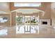 Bright living room with a modern fireplace, marble floors, and backyard access at 42 Sawgrass Ct, Las Vegas, NV 89113