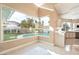 An additional sitting area looks out through large windows to the backyard and a view of the in-ground pool at 42 Sawgrass Ct, Las Vegas, NV 89113