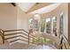 Bright staircase with marble stairs, gold banister, and gorgeous chandelier at 42 Sawgrass Ct, Las Vegas, NV 89113
