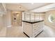 Spacious walk-in closet with custom island, shelving, and a distinctive round window at 42 Sawgrass Ct, Las Vegas, NV 89113