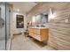 Modern bathroom with a walk-in shower, floating vanity, and unique textured wall; spa-like ambiance at 4525 Dean Martin Dr # 2806, Las Vegas, NV 89103