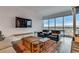 Modern living room with a wall mounted tv, comfortable chairs, and a vintage style chest at 4525 Dean Martin Dr # 2806, Las Vegas, NV 89103