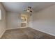 Comfortable carpeted bedroom with ceiling fan, view to en-suite bathroom, and good natural light at 4666 Monterey Cir # 4, Las Vegas, NV 89169
