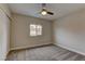 Cozy bedroom with neutral tones, a ceiling fan, and a window offering natural light at 4666 Monterey Cir # 4, Las Vegas, NV 89169