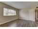 Clean, bright bedroom with laminate flooring, neutral paint and a large window at 4666 Monterey Cir # 4, Las Vegas, NV 89169