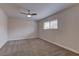 Spacious bedroom featuring neutral carpet, ceiling fan, and a bright window at 4666 Monterey Cir # 4, Las Vegas, NV 89169
